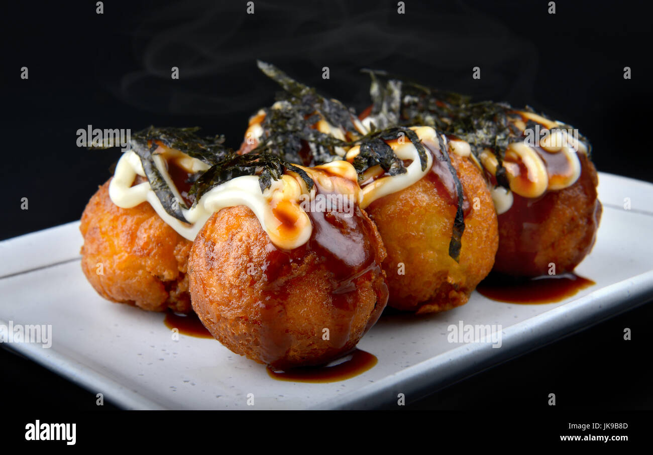 Takoyaki or Japanese octopus ball fried top on with sauce and seaweed