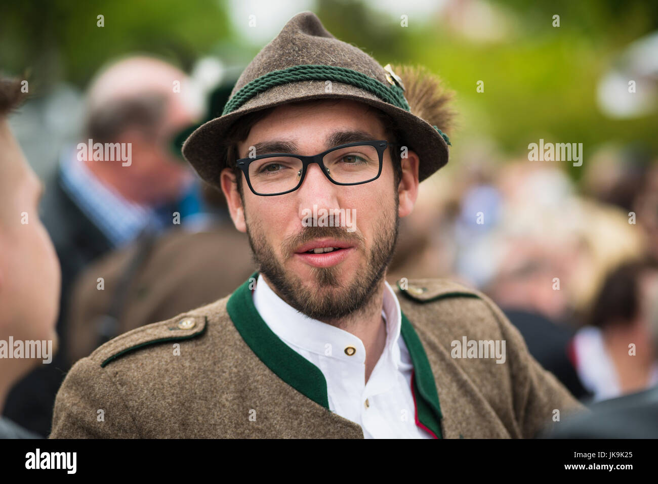 German man in traditional costume with Bavarian felt hat with tuft of hair from a chamois and buttons Stock Photo