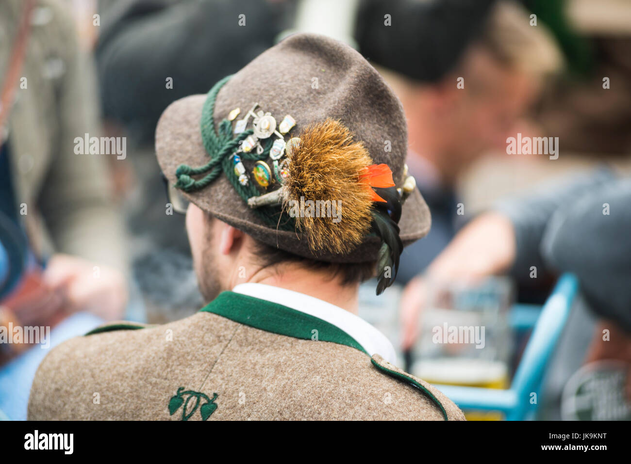 Back of a German man in traditional costume with Bavarian felt hat with tuft of hair from a chamois and buttons Stock Photo