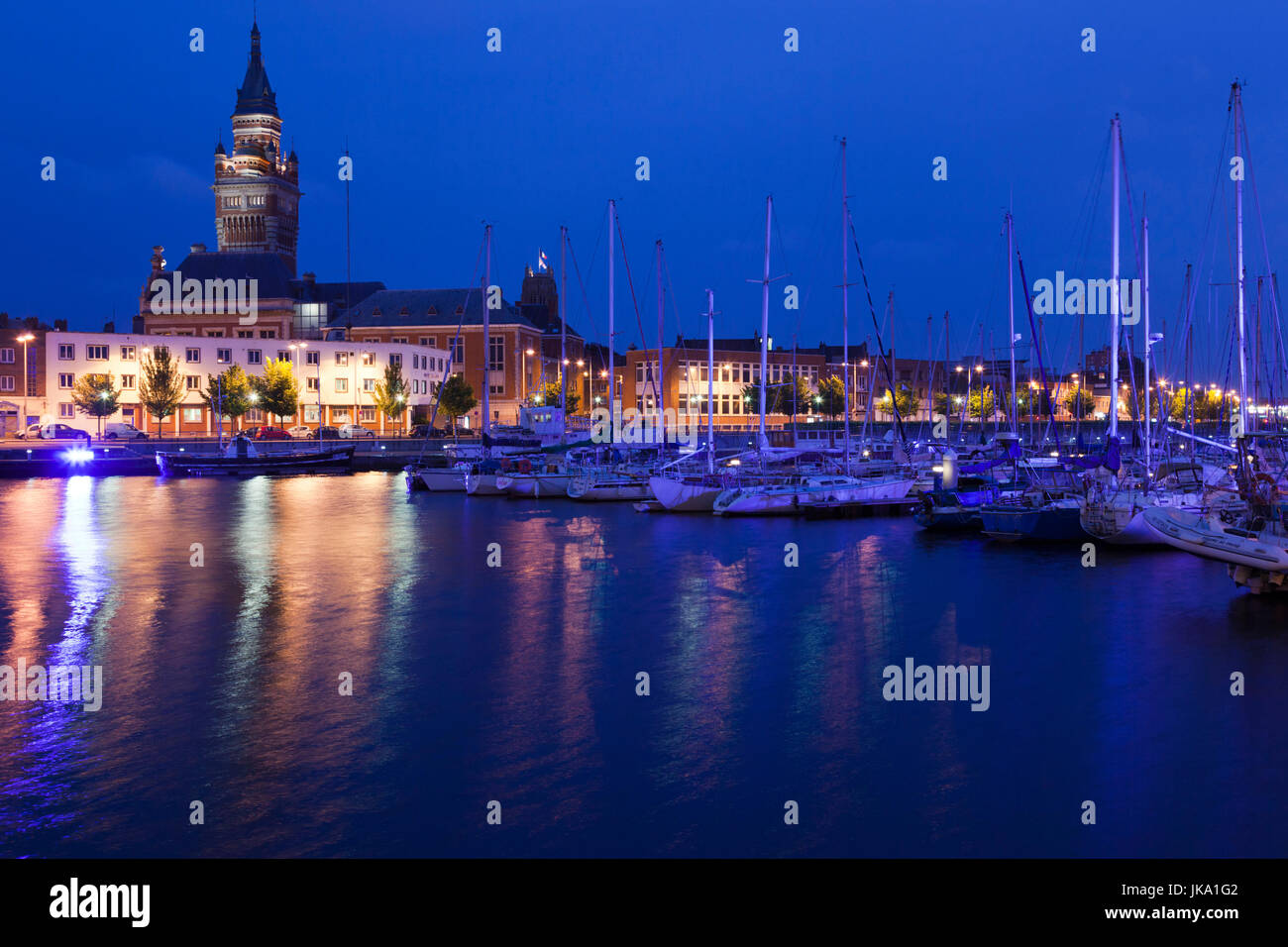 France, Nord-Pas de Calais Region, Nord Department, French Flanders Area, Dunkerque, Bassin du Commerce marina and town hall tower, dusk Stock Photo