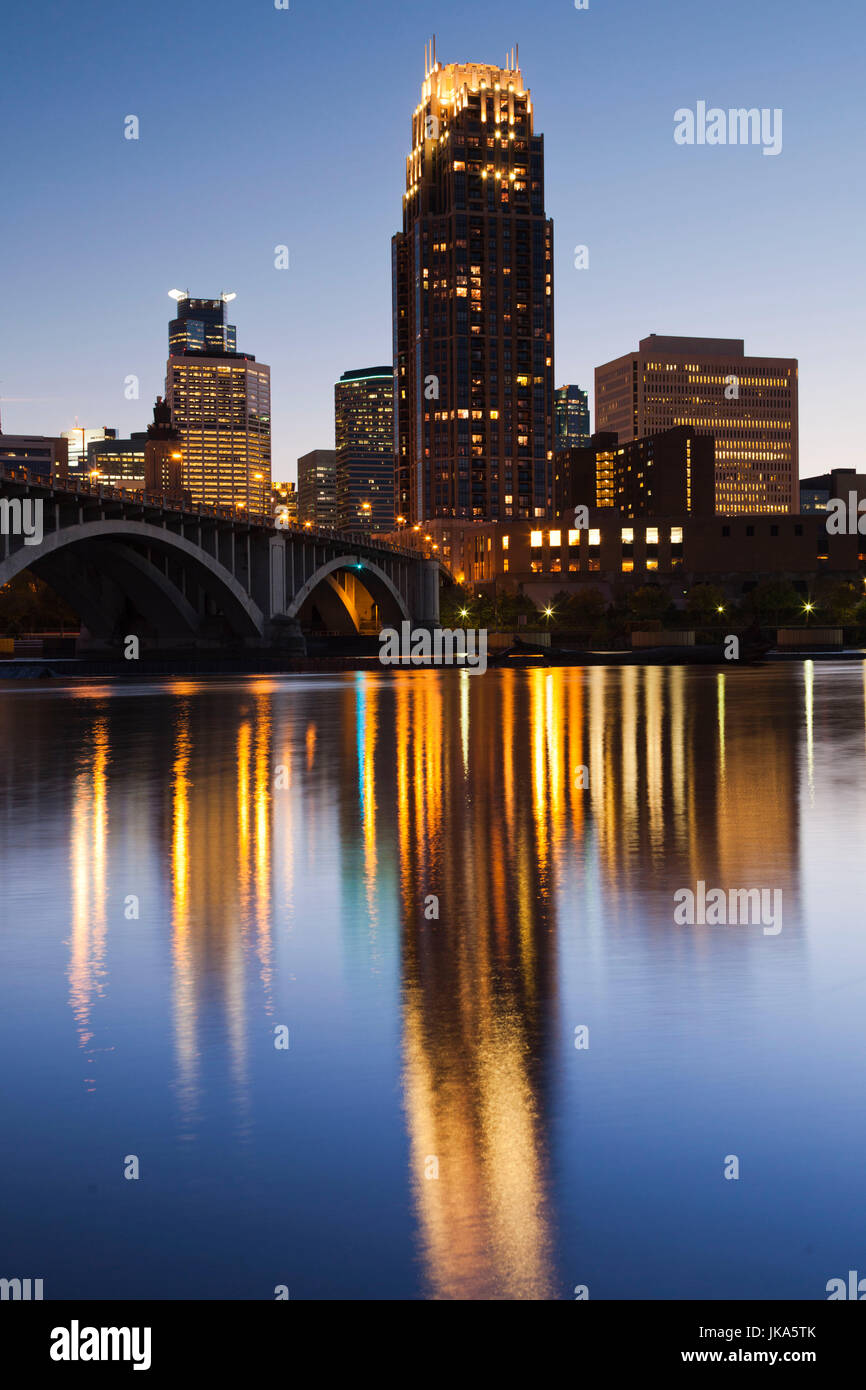 USA, Minnesota, Minneapolis, skyline with Third Avenue Bridge from Mississippi River, dusk Stock Photo
