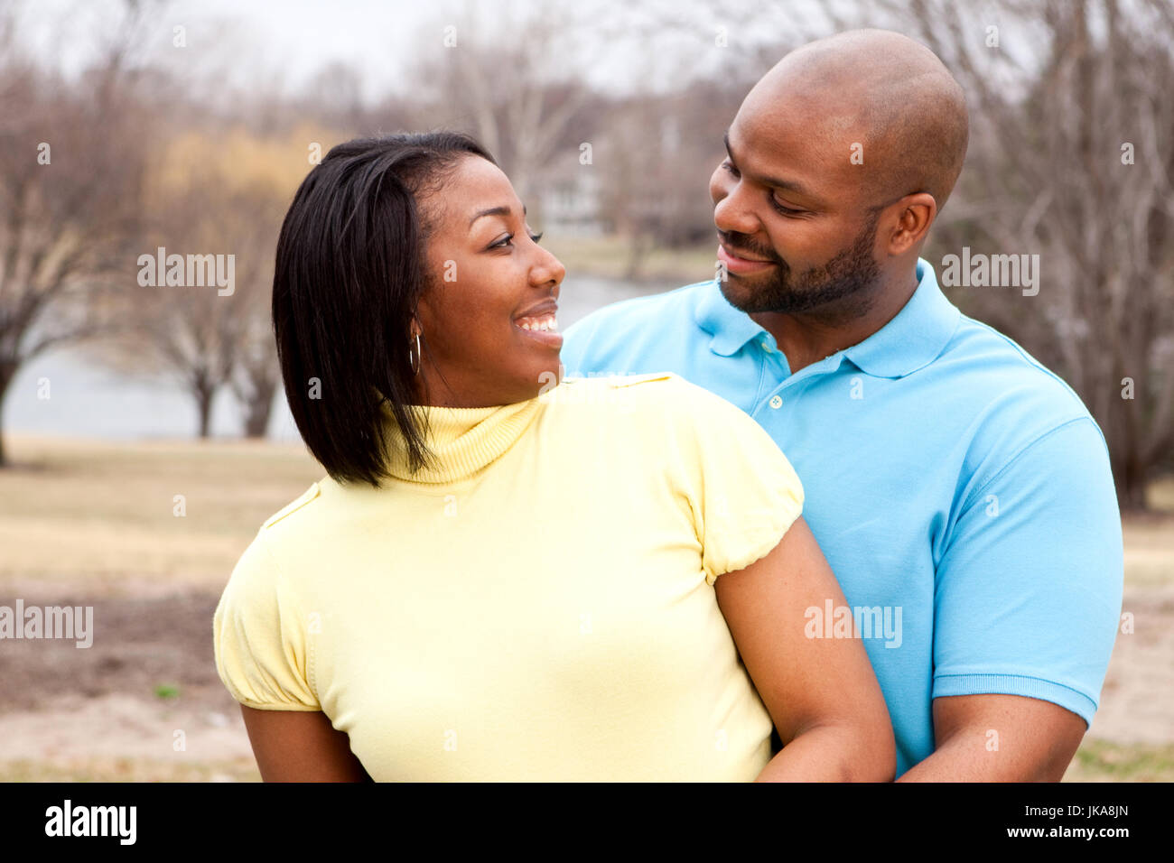 Happy African American couple hugging outside Stock Photo - Alamy