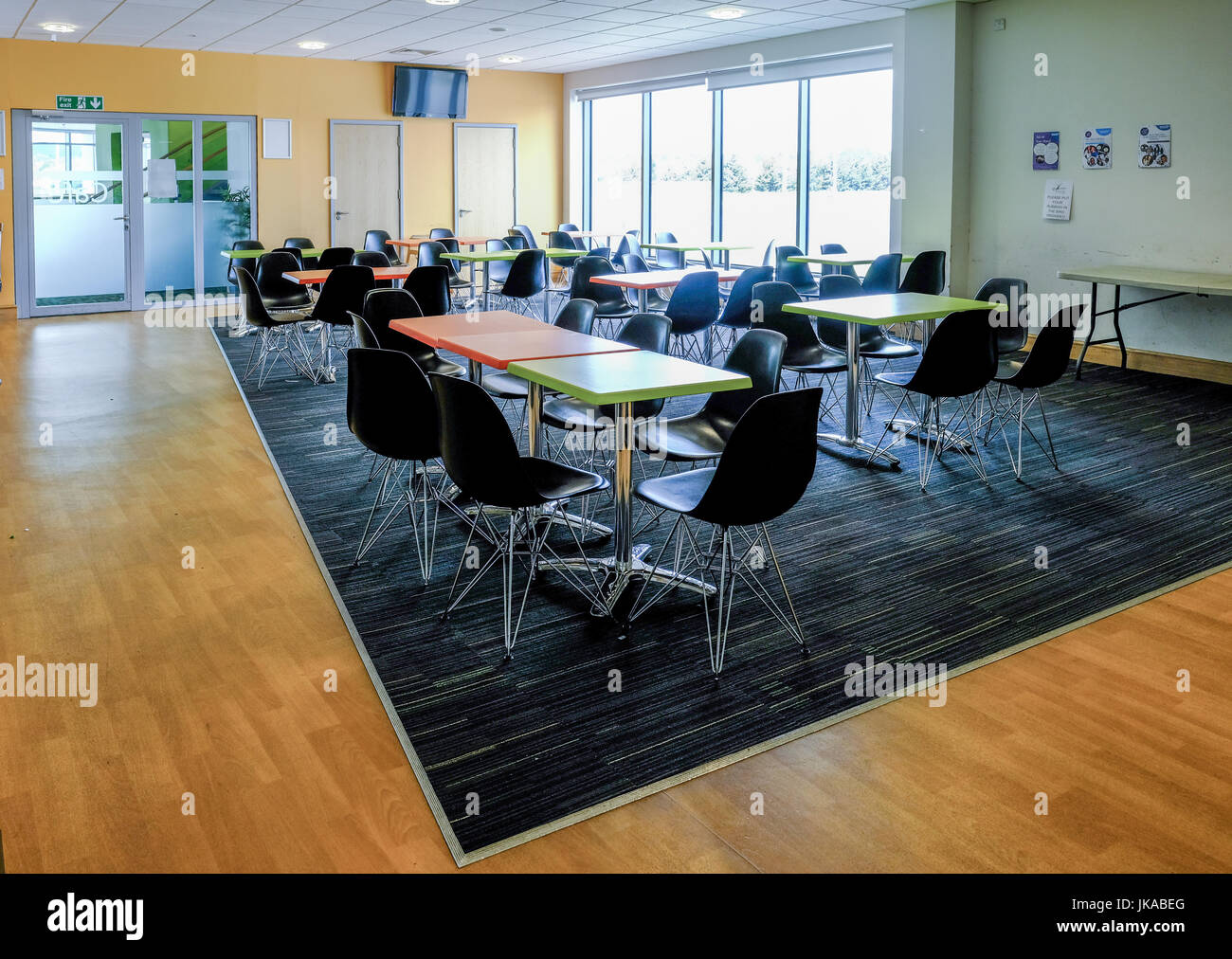 Essex, England UK -June 12, 2017:Empty canteen with tables and chairs.  Light and  airy room with light coming in from the large windows. Stock Photo