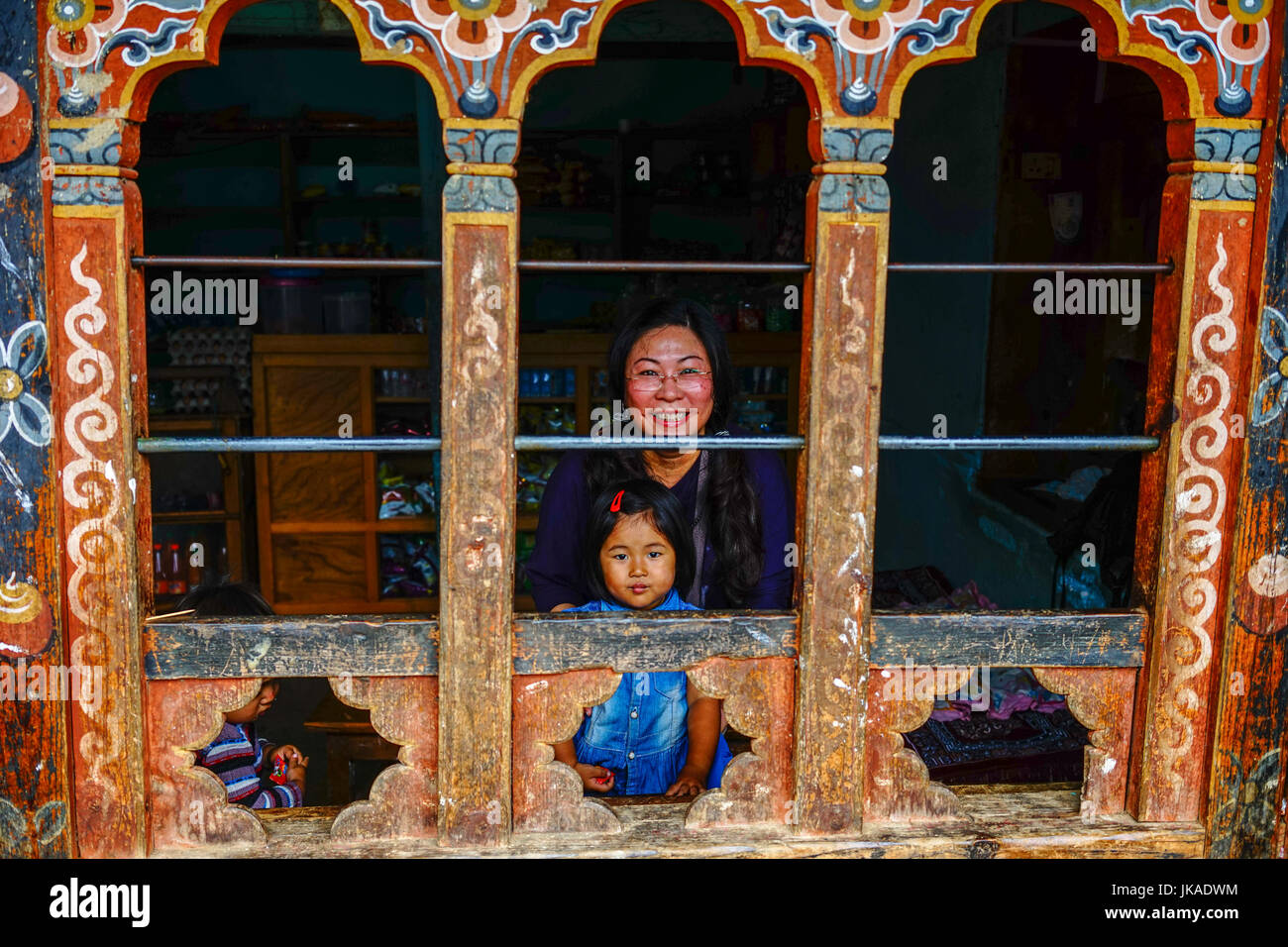 Thimphu, Bhutan - Aug 29, 2015. A Tibetan woman with her child at a traditional house in Thimphu, Bhutan. Bhutan is a small country in the Himalayas b Stock Photo