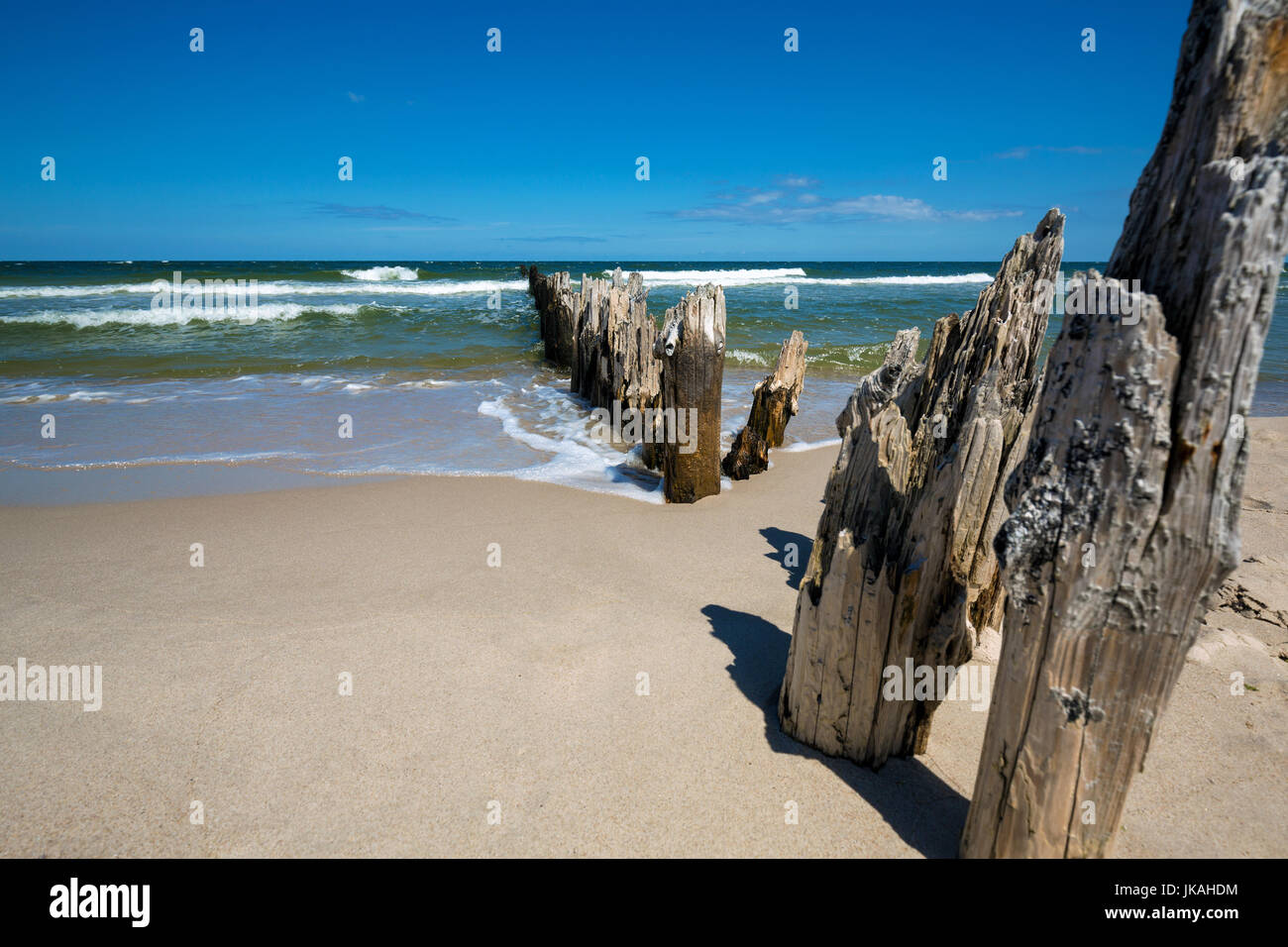 Old wooden breakwater over the Baltic Sea on a sunny day Stock Photo