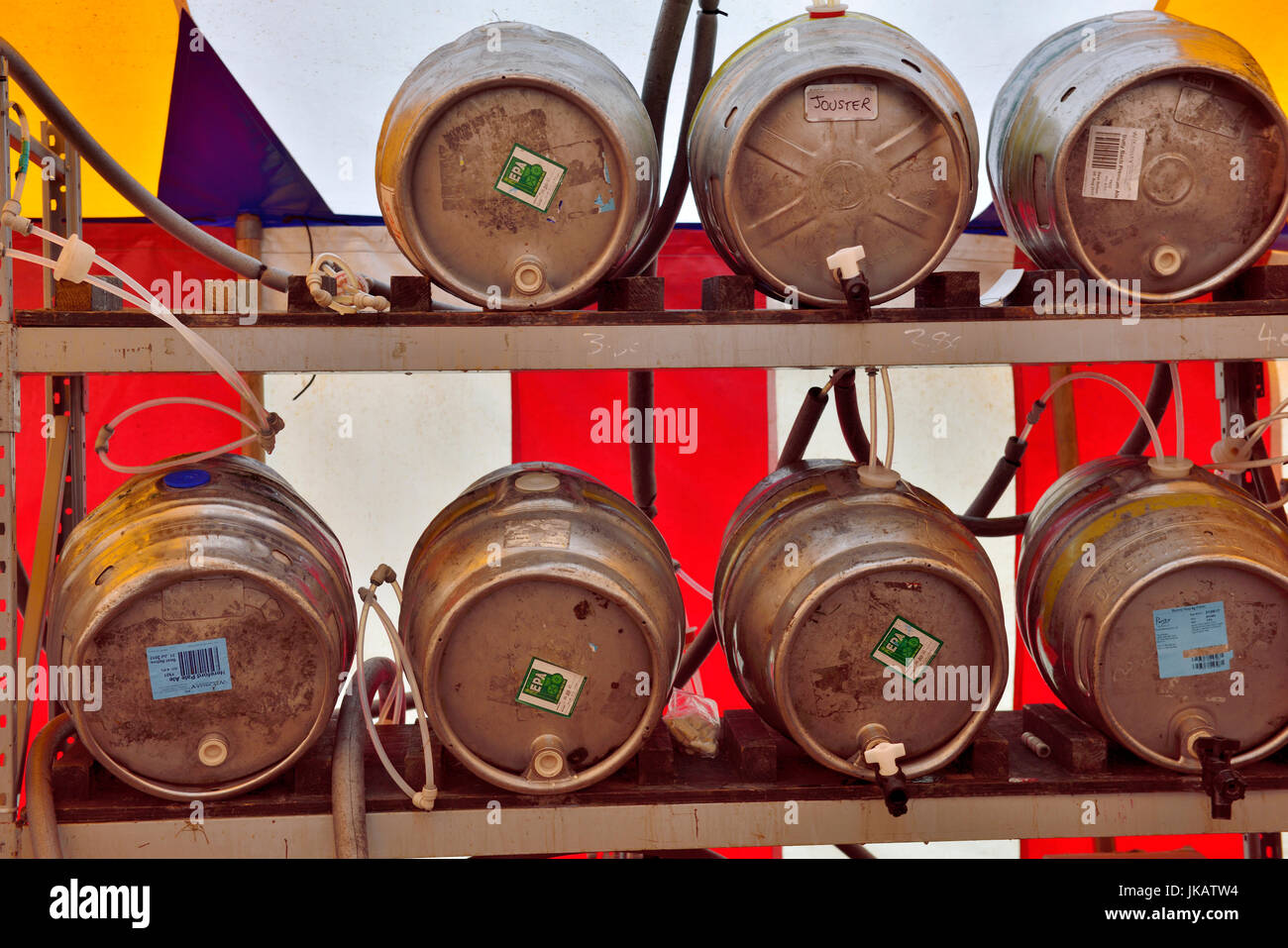 Row of steel beer barrels in festival marquee Stock Photo