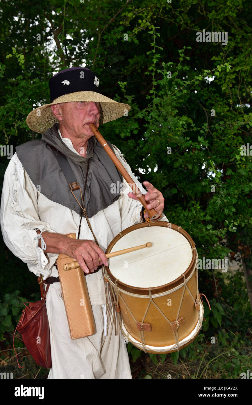 Musician in costume playing flute and drum at Tewkesbury Medieval re