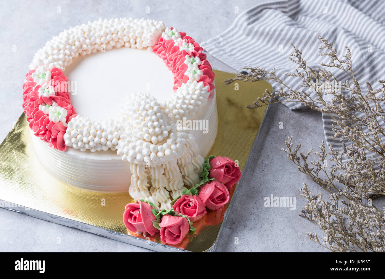 whipping cream cake decoration as a jasmine garland on marble table, sweet dessert Stock Photo