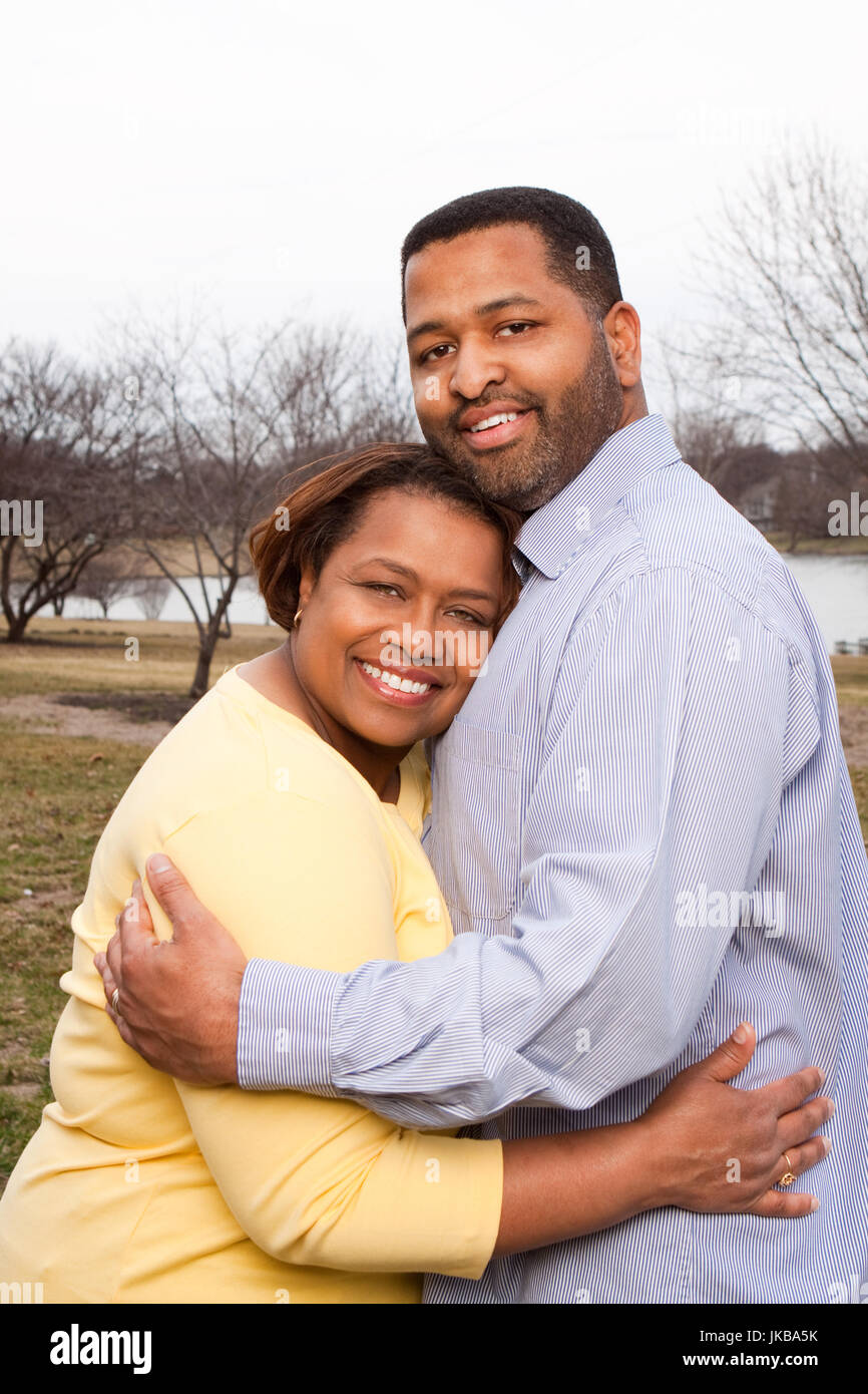Happy African American couple hugging outside Stock Photo - Alamy
