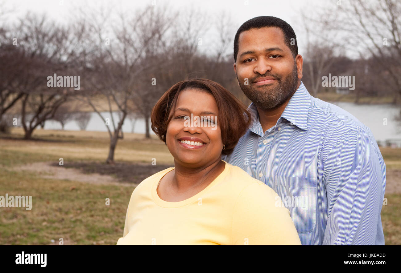 Happy African American couple hugging outside Stock Photo - Alamy