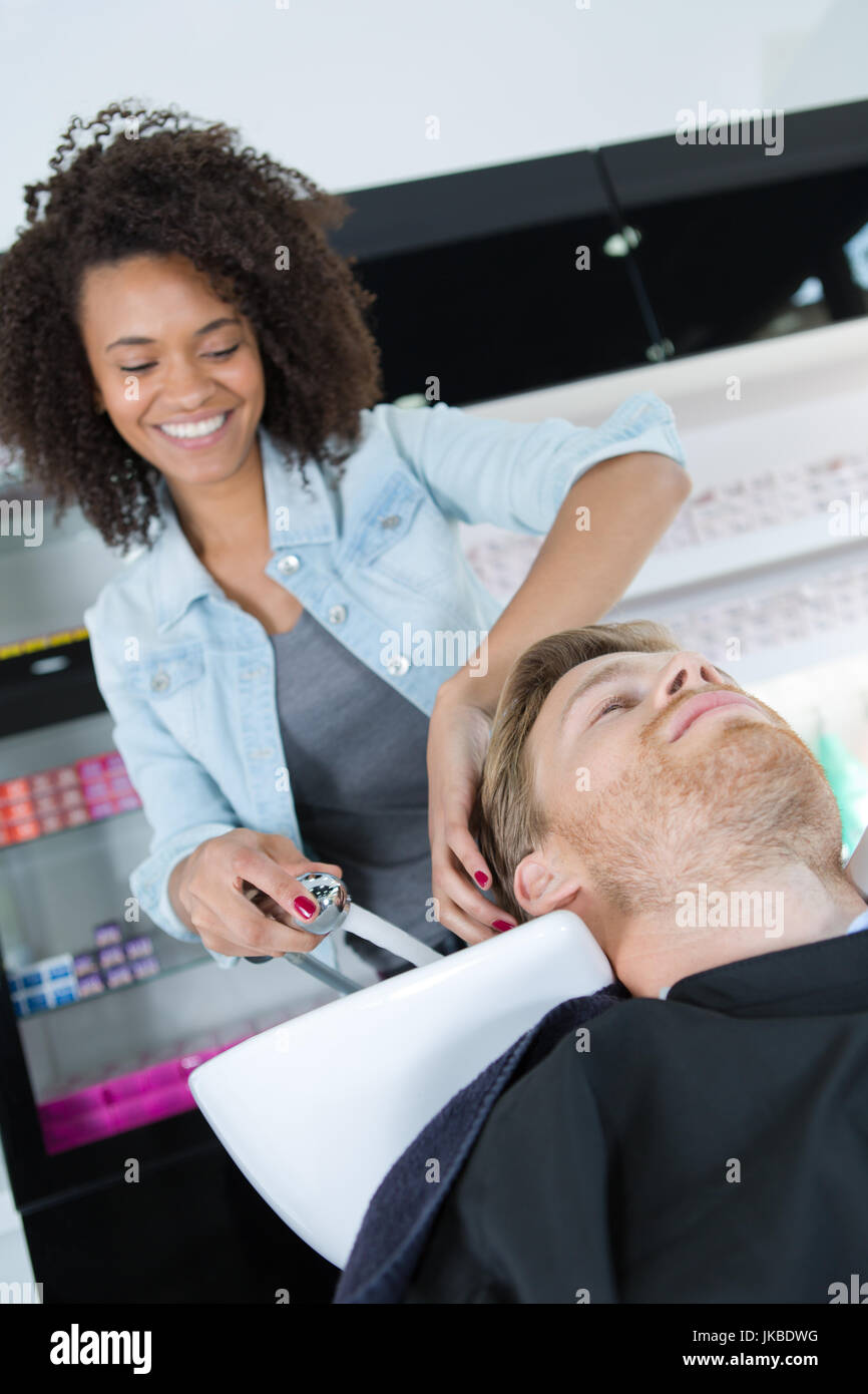 barber washing hair client wash hair Stock Photo Alamy