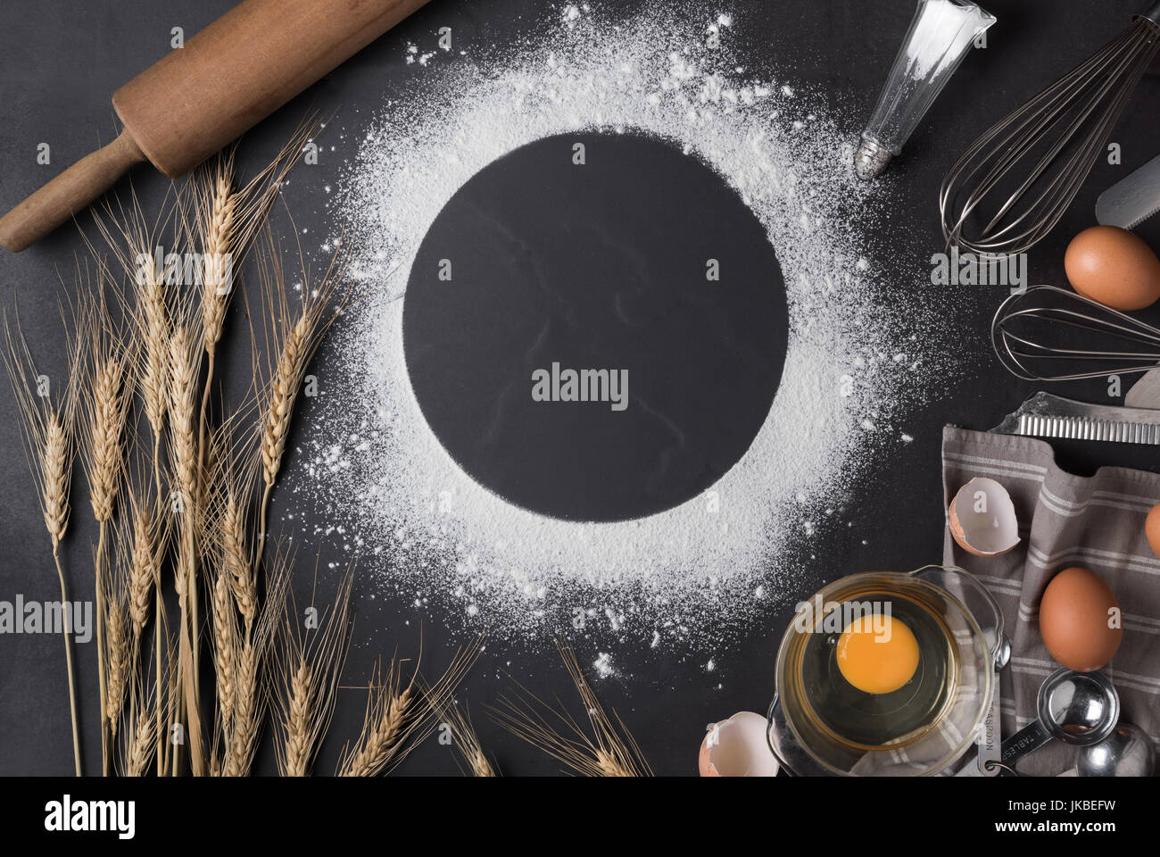 Baking utensils and ingredient with whisk egg on black background, Frame border design text space images. Stock Photo