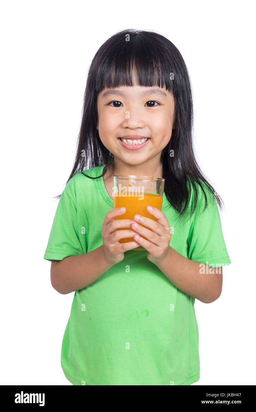 Happy Asian Chinese little girl drinking orange juice in isolated white ...