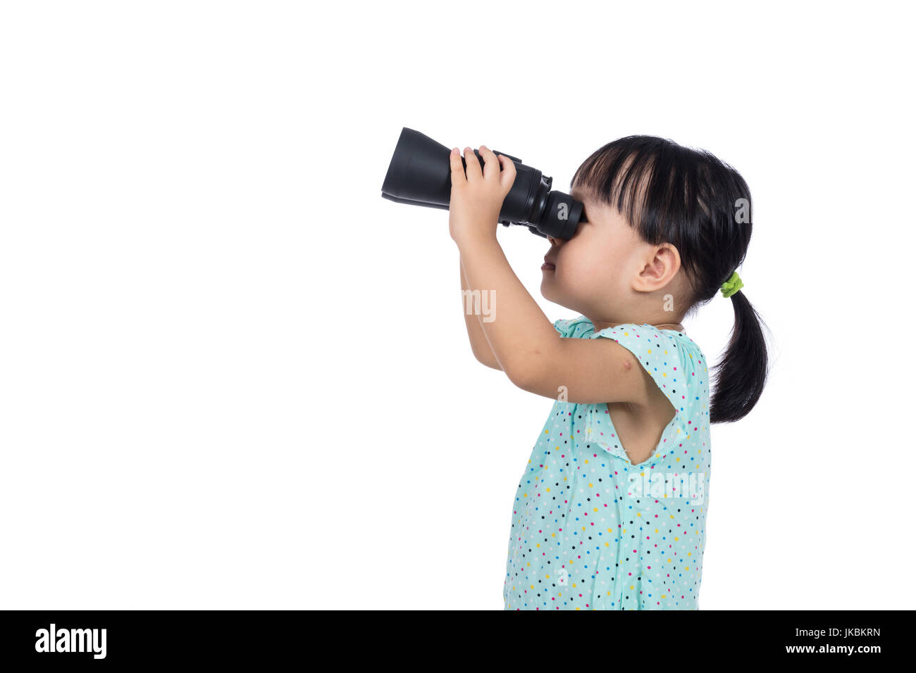 Asian Chinese little girl holding binoculars in isolated white background Stock Photo