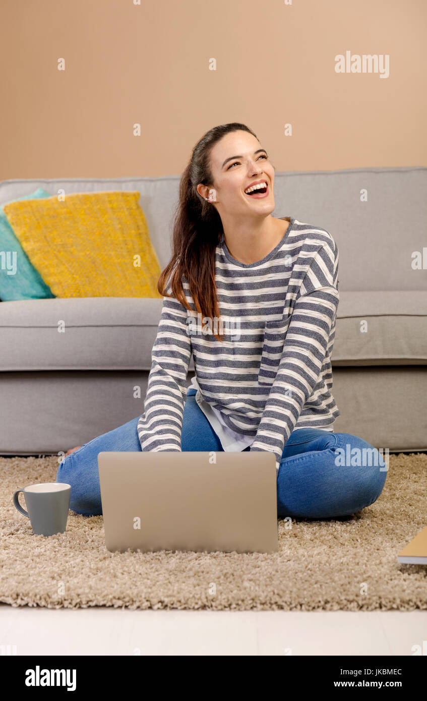 Beautiful woman at home working with a laptop Stock Photo - Alamy