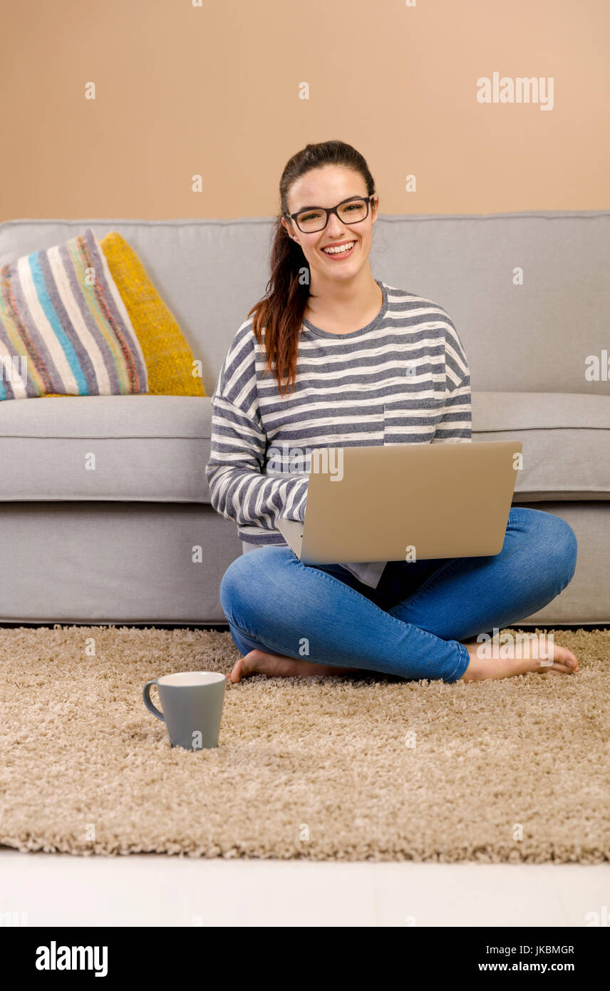 Beautiful woman at home working with a laptop Stock Photo - Alamy