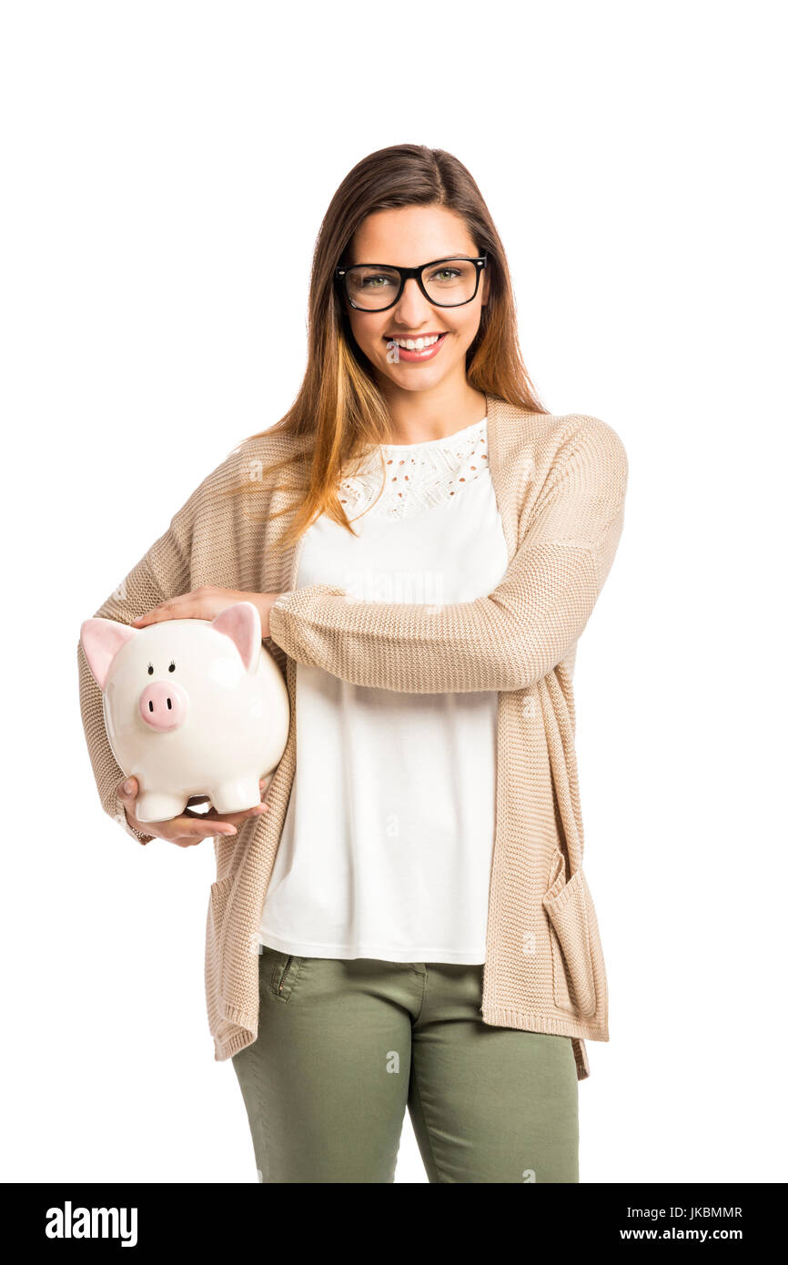 Beautiful and happy woman holding a piggy bank, isolated over white ...