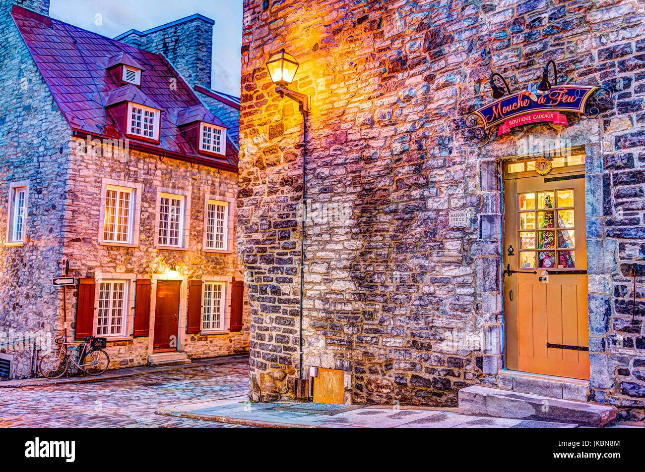 Quebec City, Canada - May 31, 2017: Colorful stone buildings on street during twilight in lower old town with Mouche a Feu boutique Stock Photo