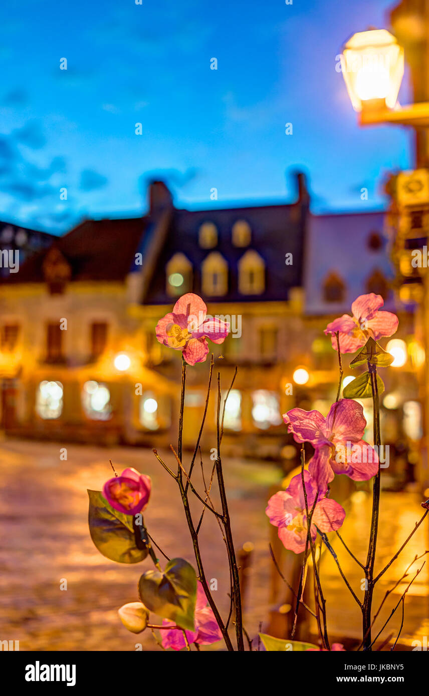 Closeup of fake cloth orchid flowers at night with bokeh background on  illuminated European street Stock Photo - Alamy