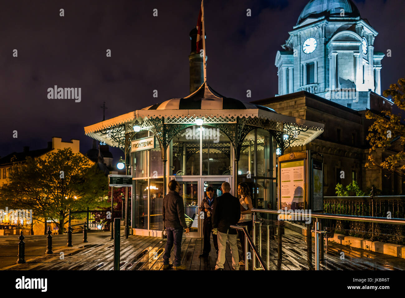 Quebec City, Canada - May 31, 2017: Old town view of people on dufferin terrace at night with illuminated Funiculaire building gazebo Stock Photo