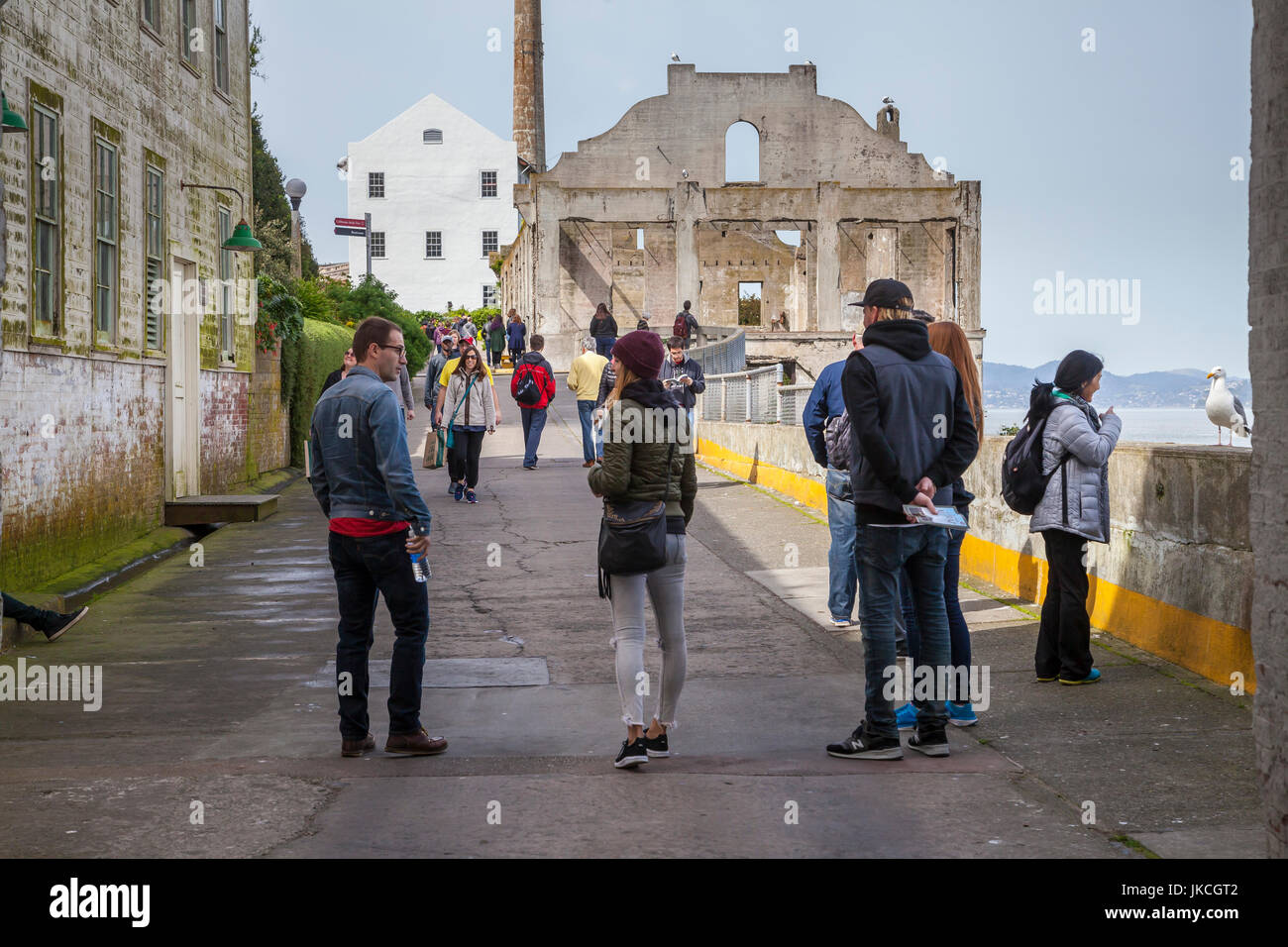 Tourists walking toward officer's club in Alcatraz penitentiary, San Francisco, California, USA Stock Photo