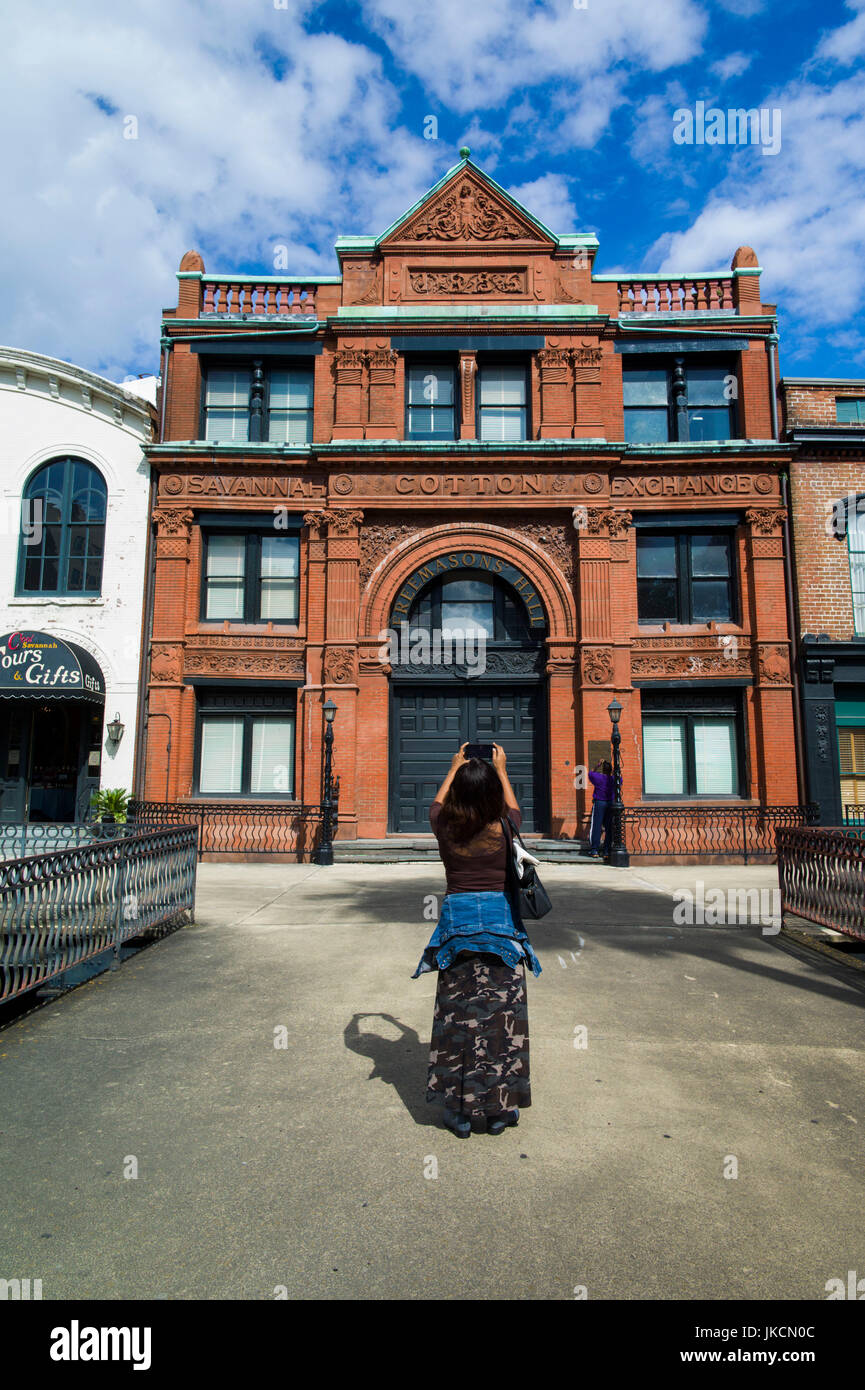 Savannah cotton exchange building tourist with cell phone camera hires