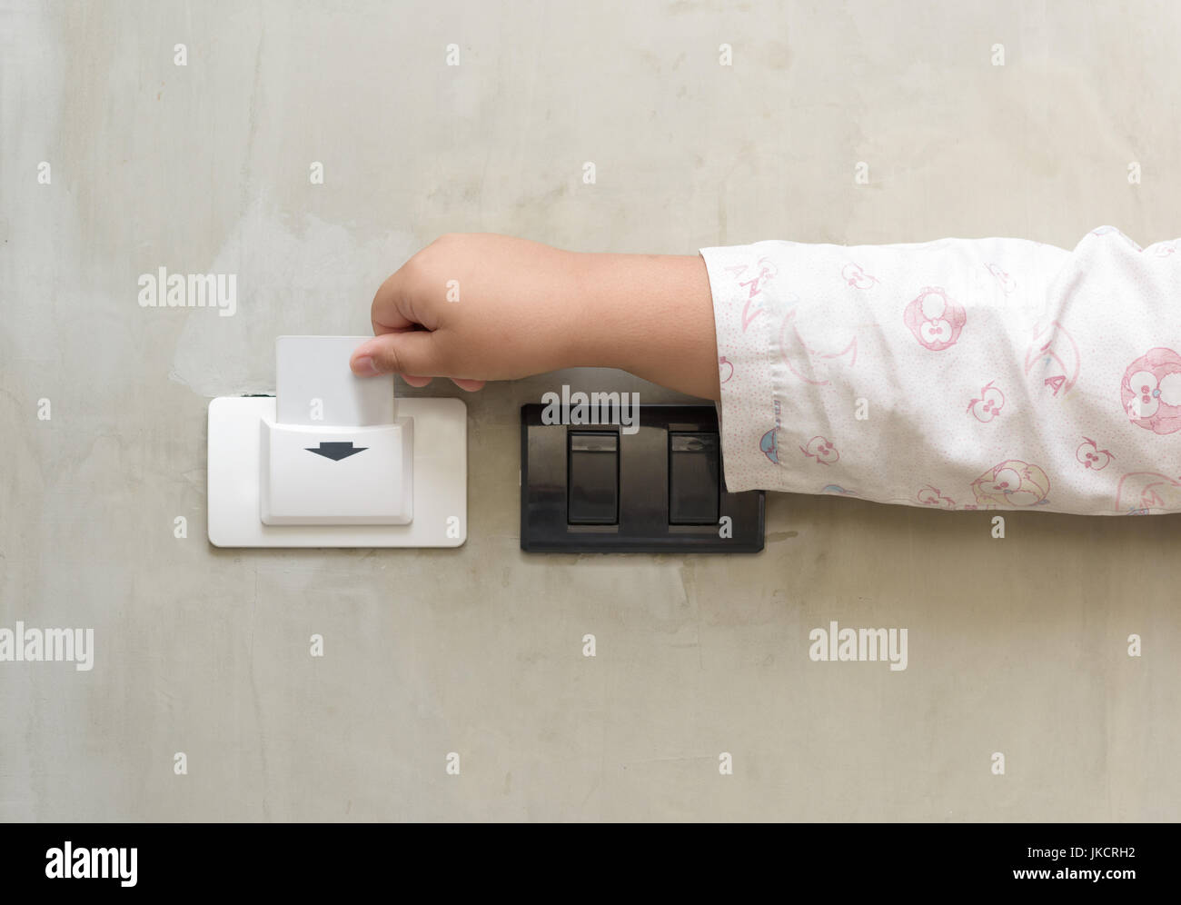 child putting key card switch in hotel room Stock Photo