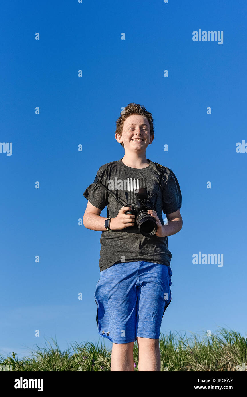 Teenager with DSLR camera. Stock Photo