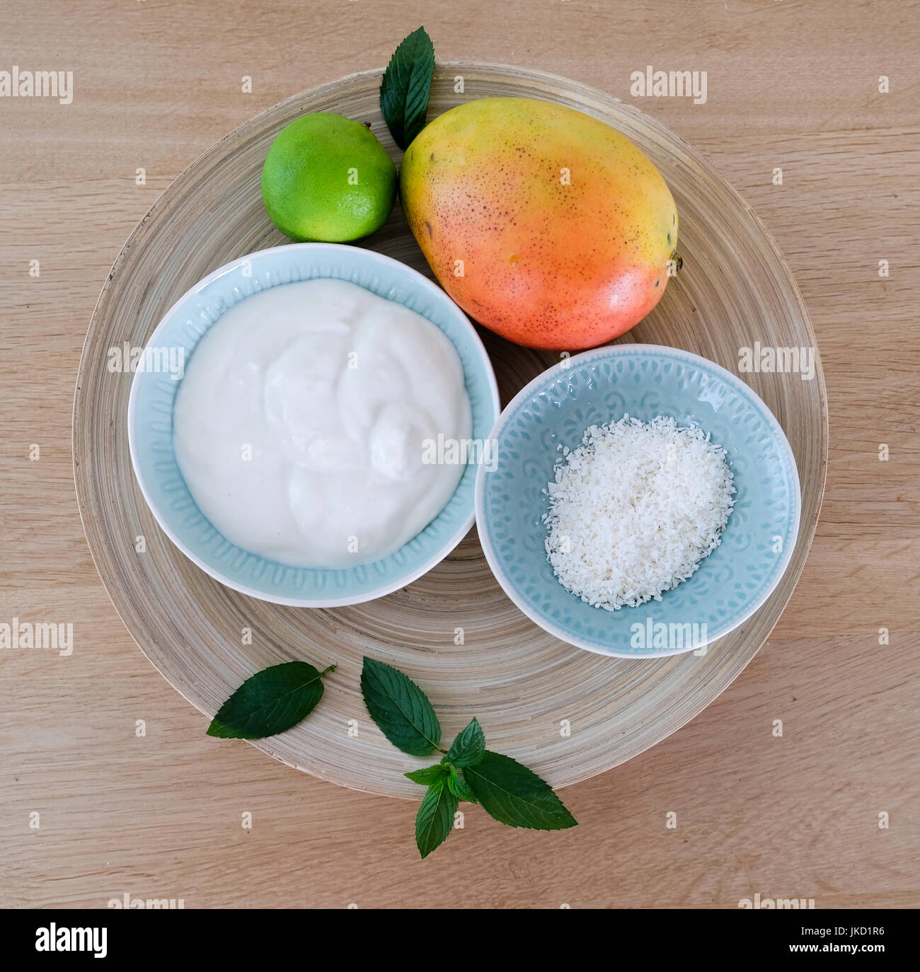 Ingredients for a healthy mango-smoothie with cocos, lime and mint Stock Photo
