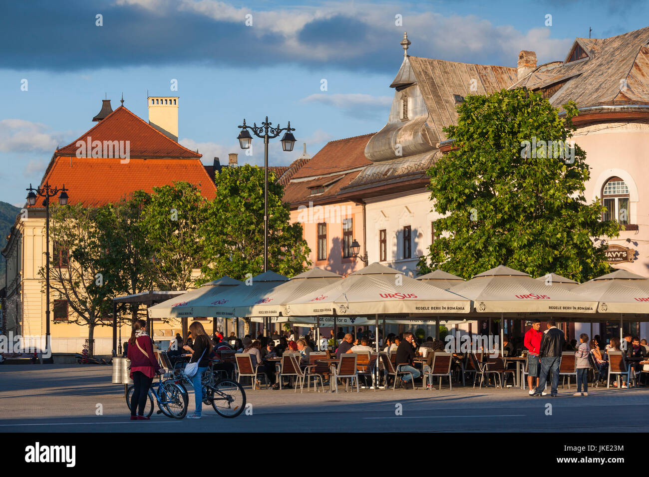 Romania, Maramures Region, Baia Mare, Piata Libertatii Square, outdoor cafes, late afternoon Stock Photo