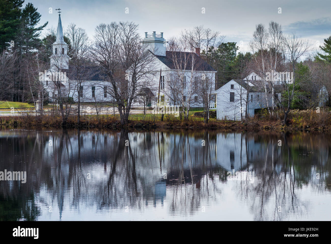 USA, New Hampshire, Marlow, buildings around Village Pond, late fall