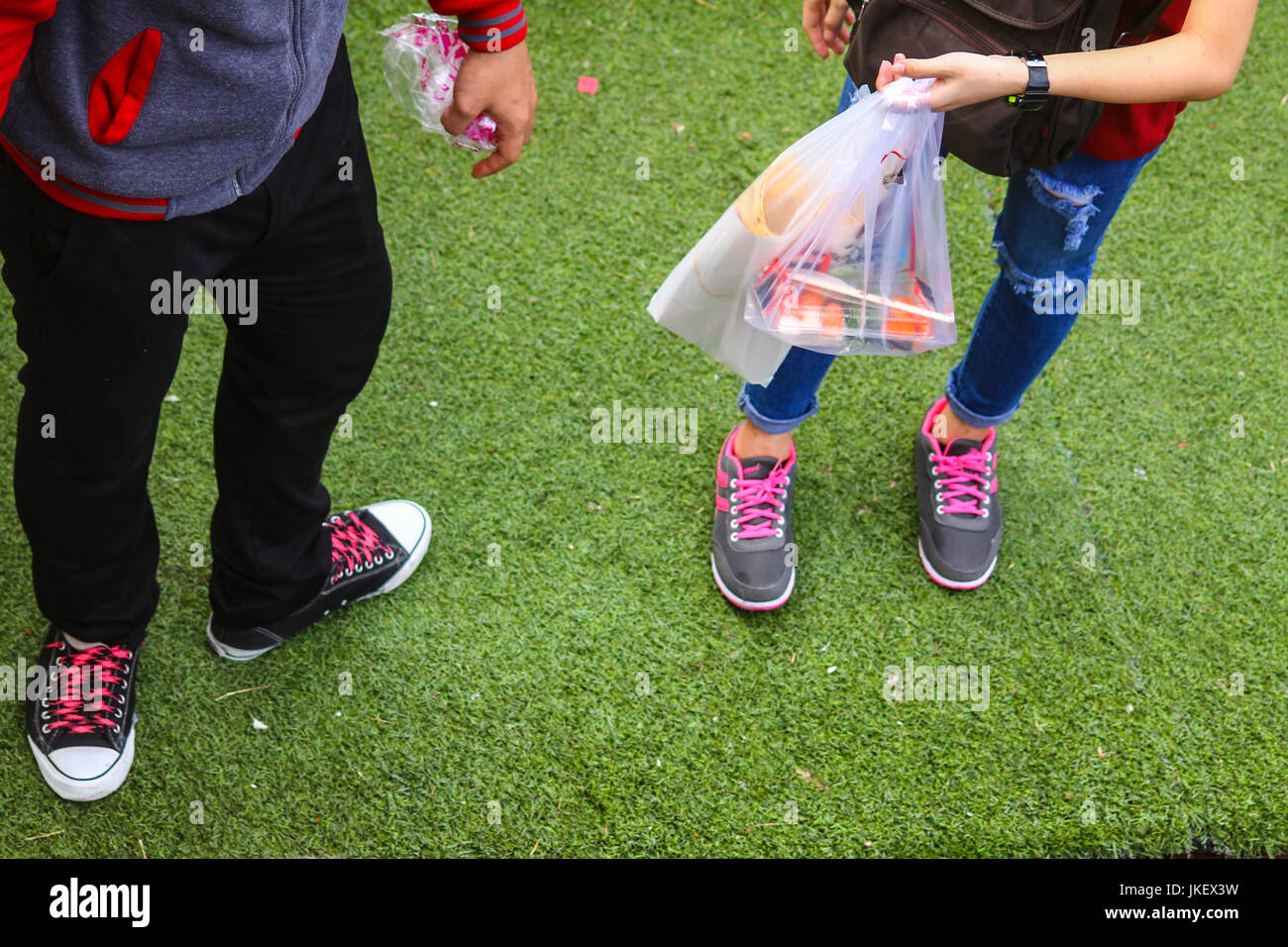 low section shot showing a couple with matching colored shoe laces Stock Photo