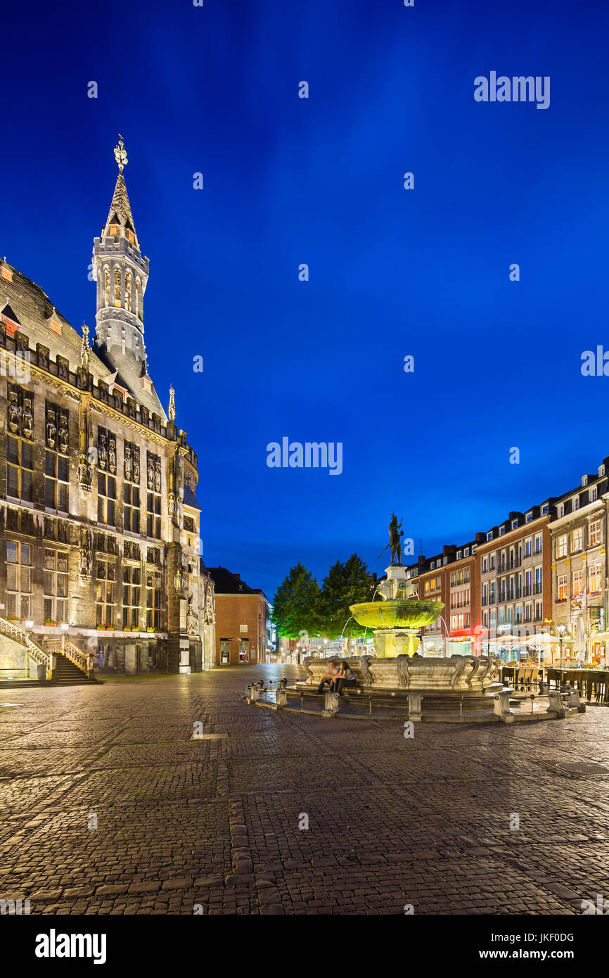 AACHEN - JUNE 05: Vertical view of the famous old town hall of Aachen, Germany with night blue sky seen from the market square with the Karlsbrunnen t Stock Photo