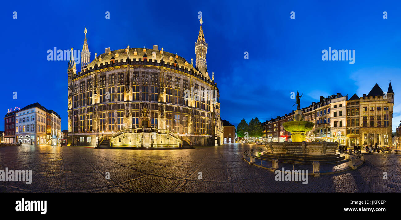 AACHEN - JUNE 05: Panoramic view of the famous old town hall of Aachen, Germany with night blue sky on the market square with the Karlsbrunnen to the  Stock Photo