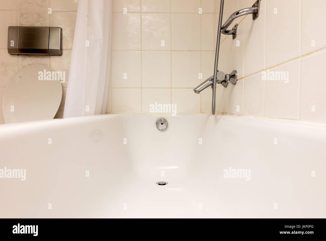 Old white bathtub in a tiled bathroom Stock Photo - Alamy