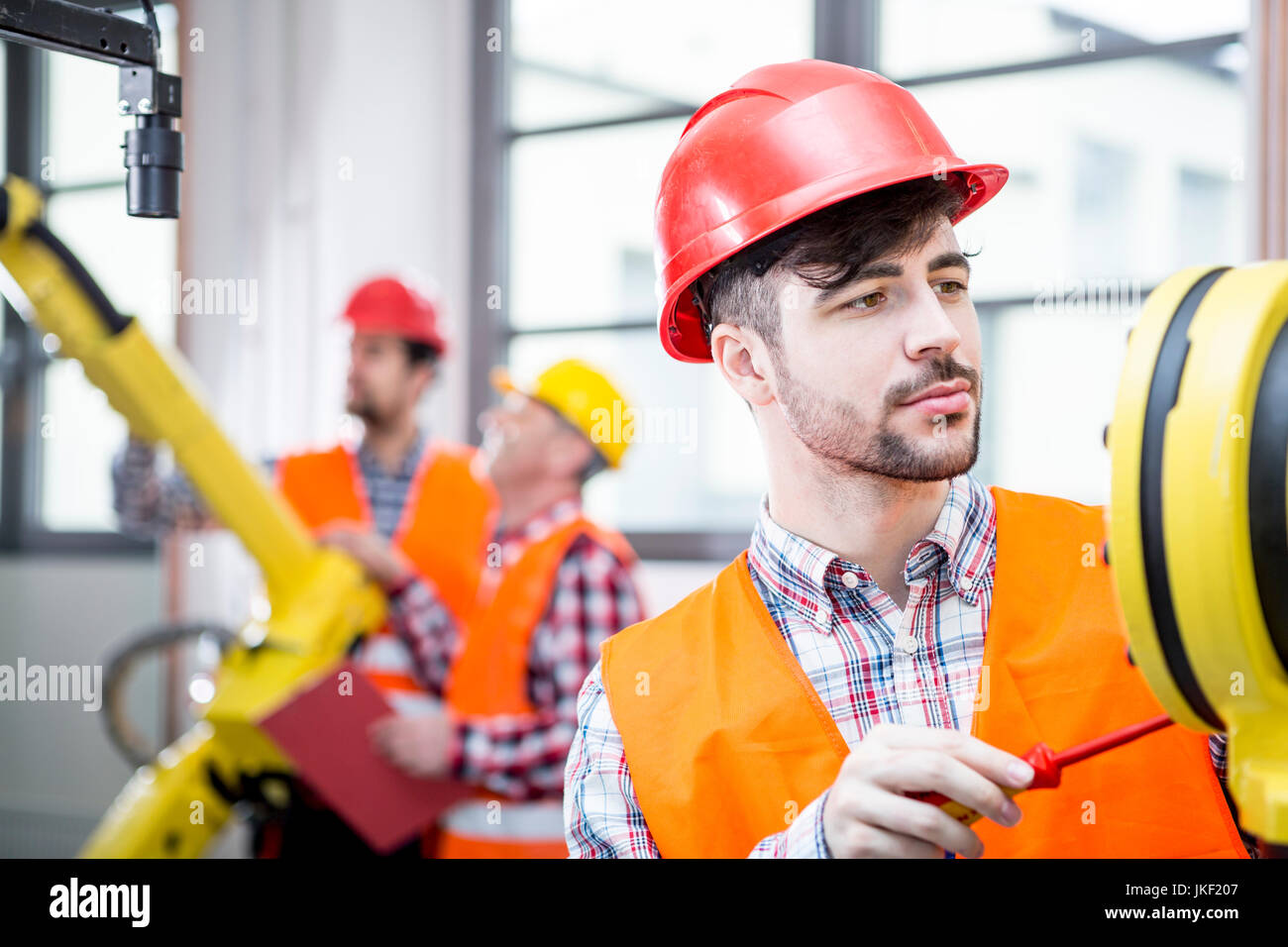 Technician working on industrial robot Stock Photo Alamy
