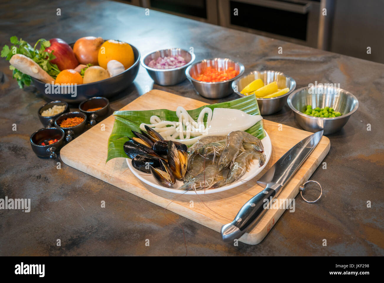 Raw seafood on plate with fruits and vegetables, healthy food, prawn, clam squid. Stock Photo
