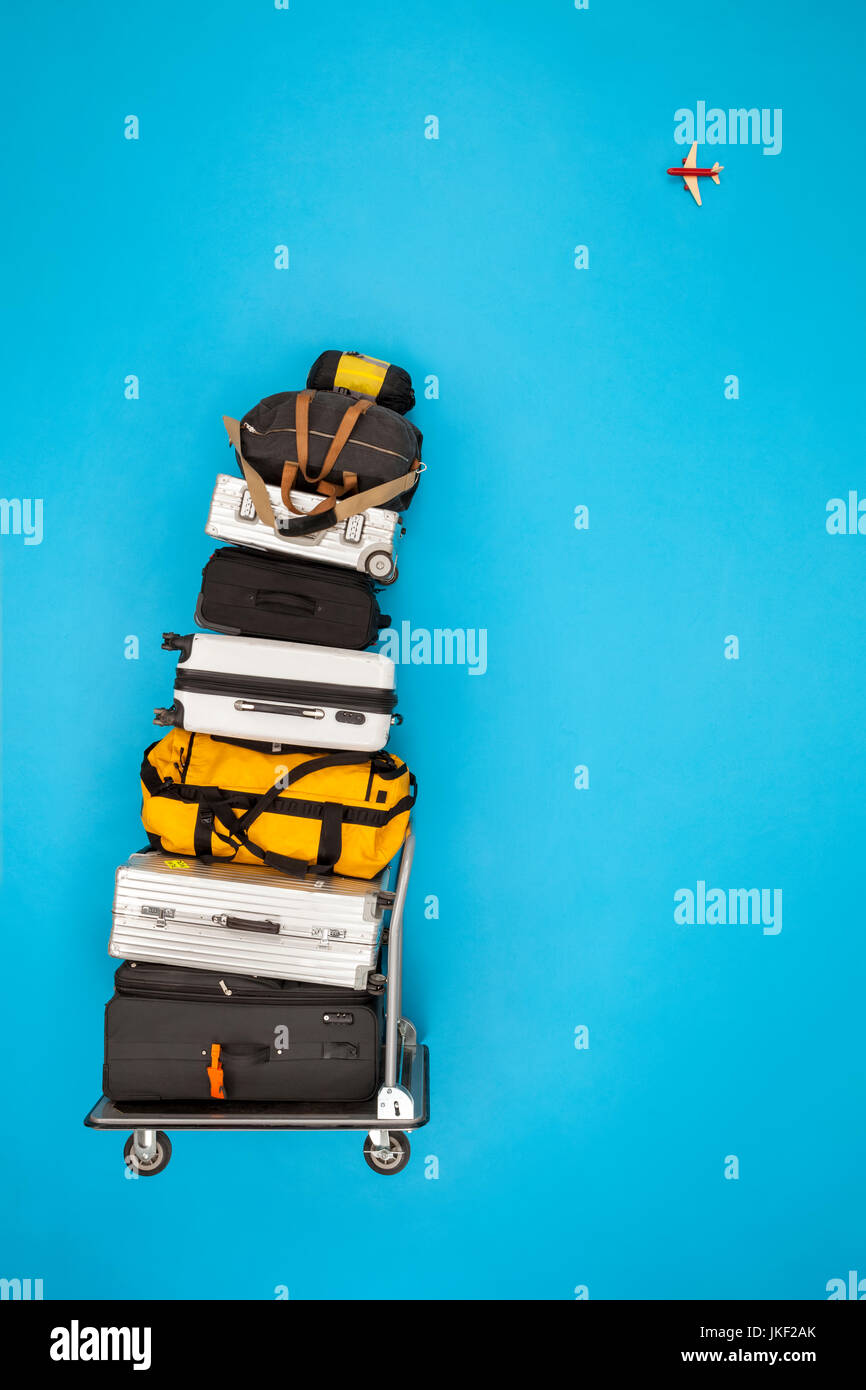 Stacked luggage and plane flying in the sky Stock Photo Alamy