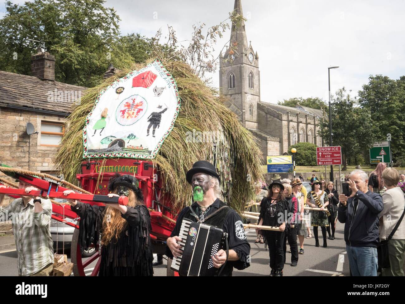 People take part in the Rush Cart procession during the Rushbearing Festival, which dates back to the 10th Century AD, in Littleborough near Manchester. Stock Photo