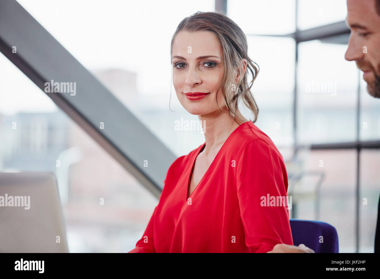Portrait of smiling woman in office Stock Photo - Alamy