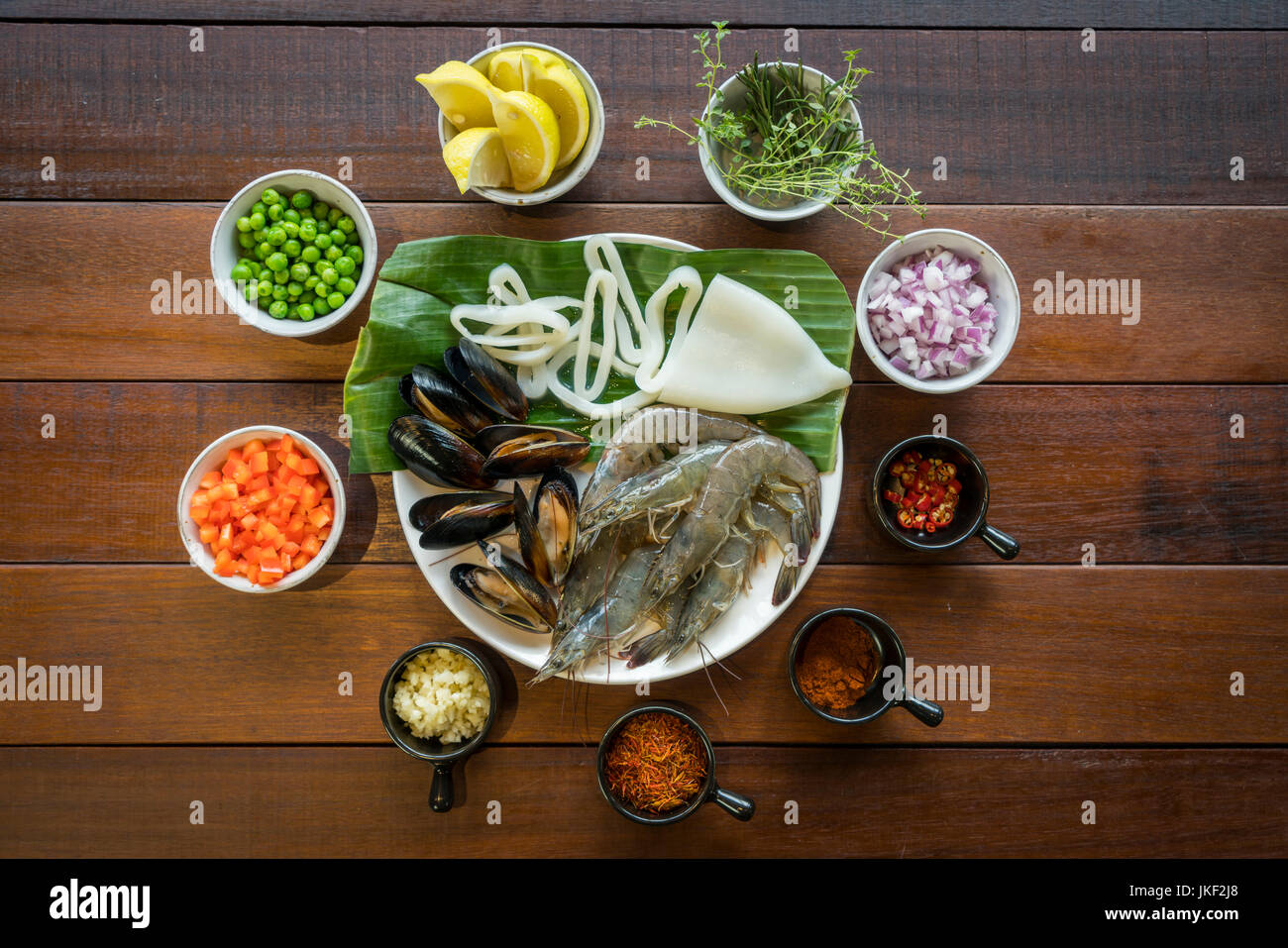 Overhead shot of Raw seafood on plate, healthy food, prawn, clam squid. Stock Photo