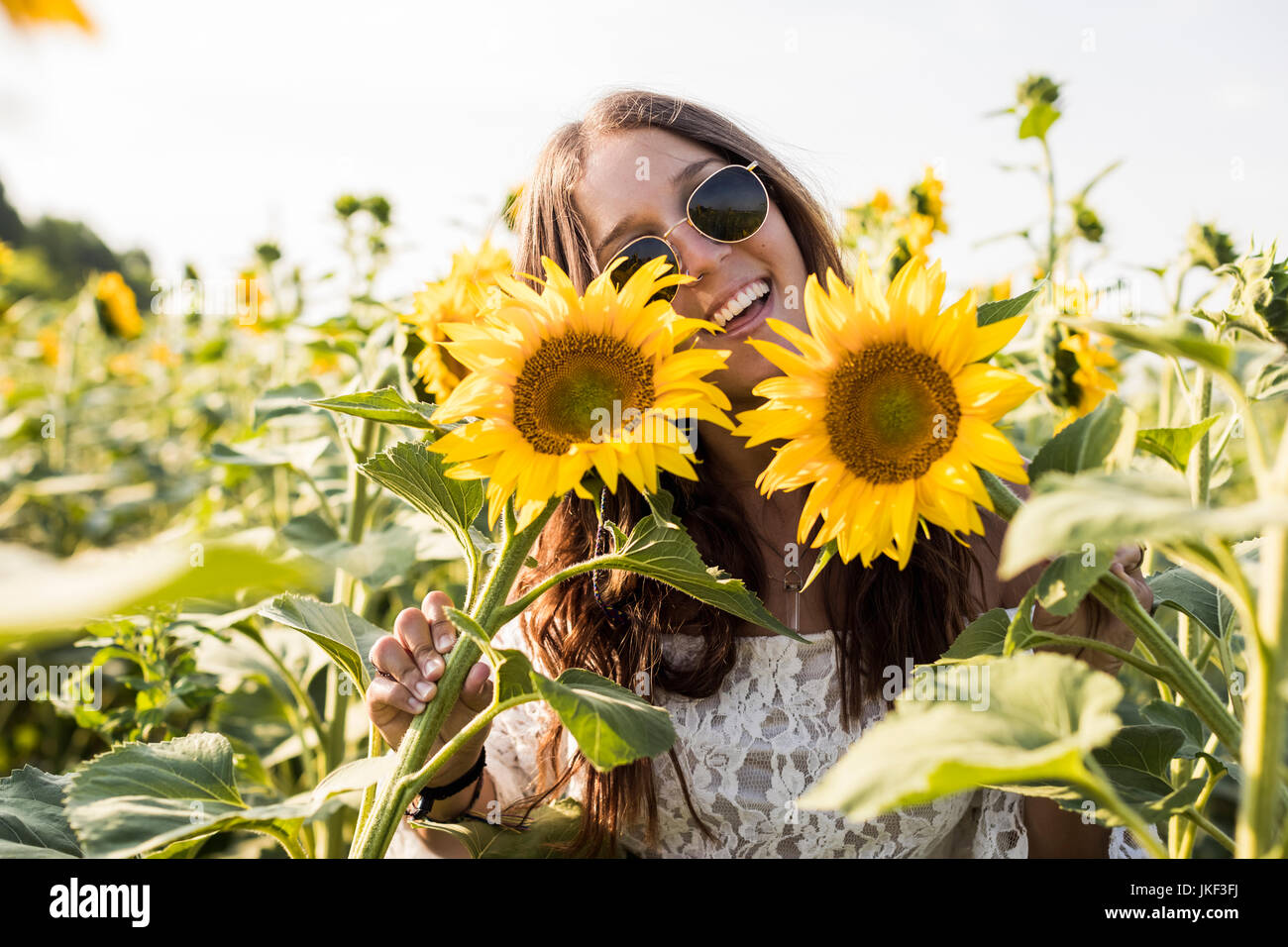 Beautiful Woman in a Sunflower Field Stock Photo - Alamy