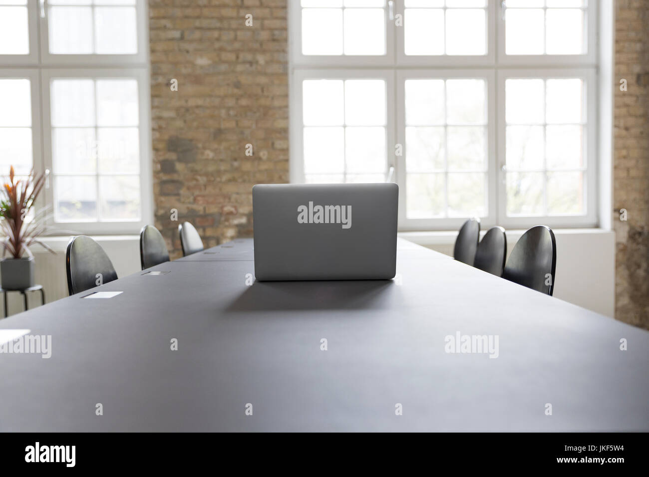 Laptop on conference table Stock Photo