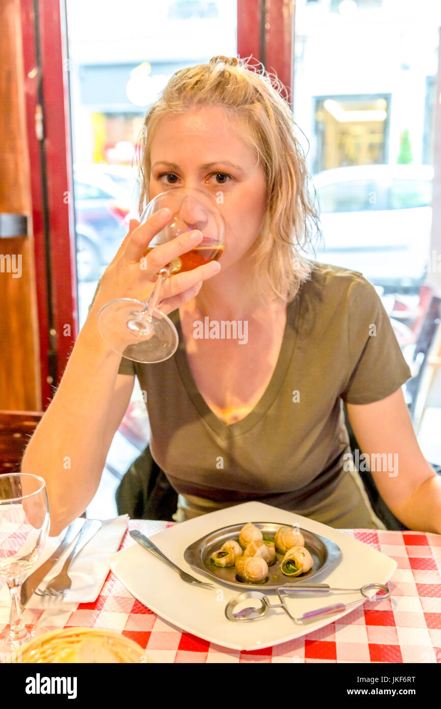 Woman eating snails Stock Photo