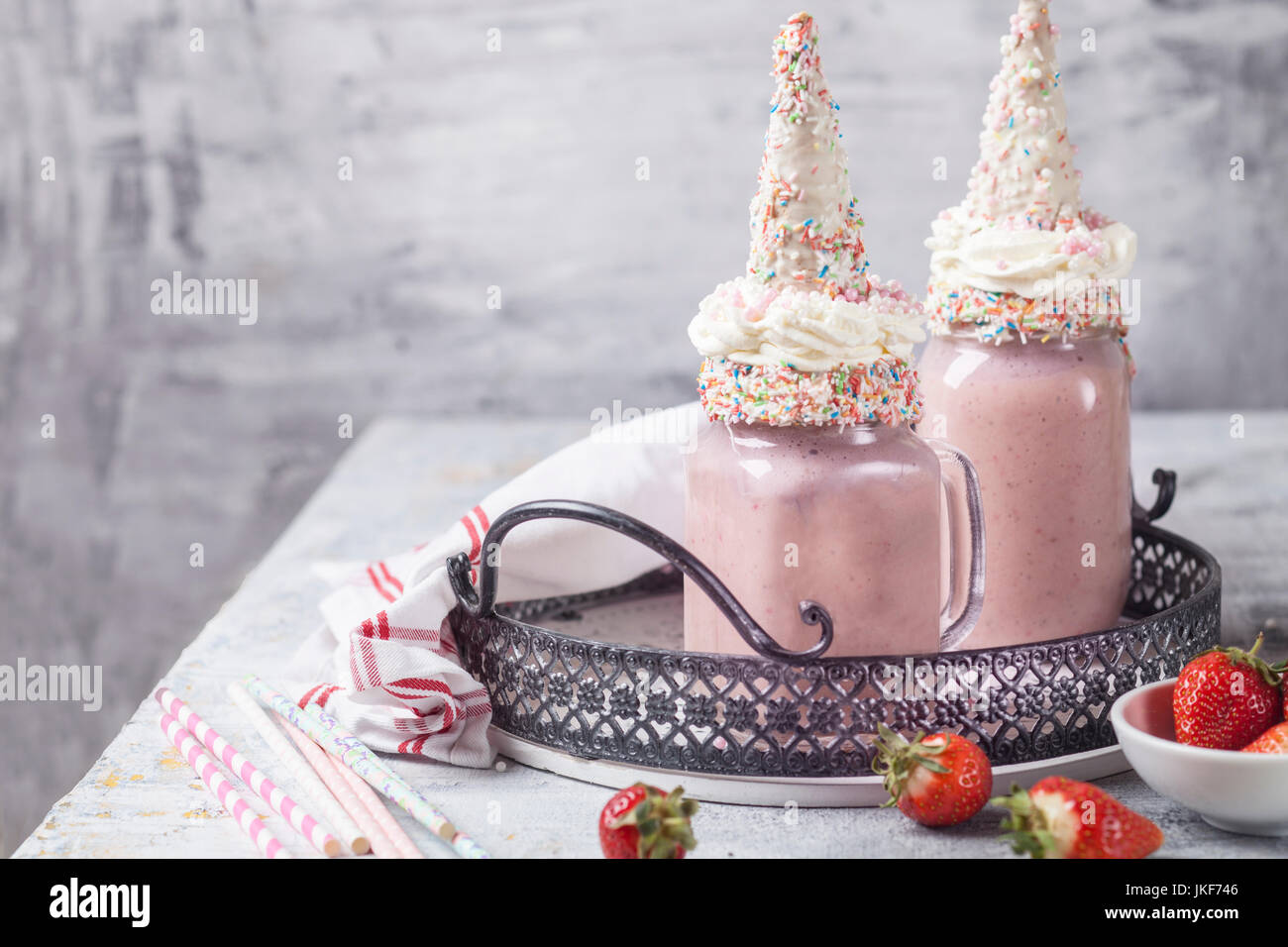 Unicorn shake with cream and chocolate-covered cone Stock Photo