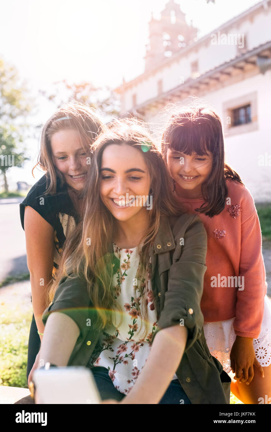 Three happy girls taking a selfie outdoors Stock Photo - Alamy