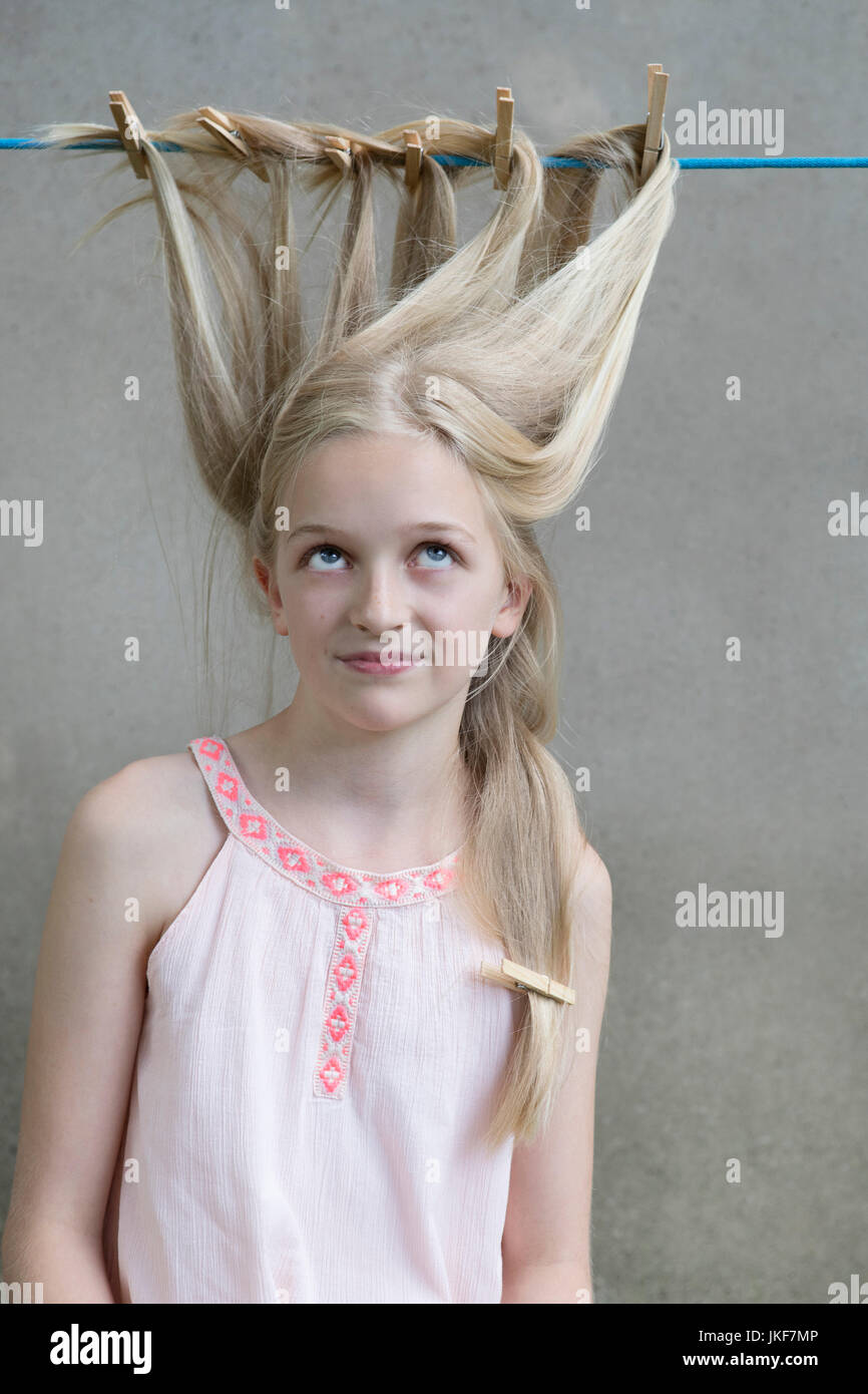 Blond girl's hair drying on clothesline Stock Photo