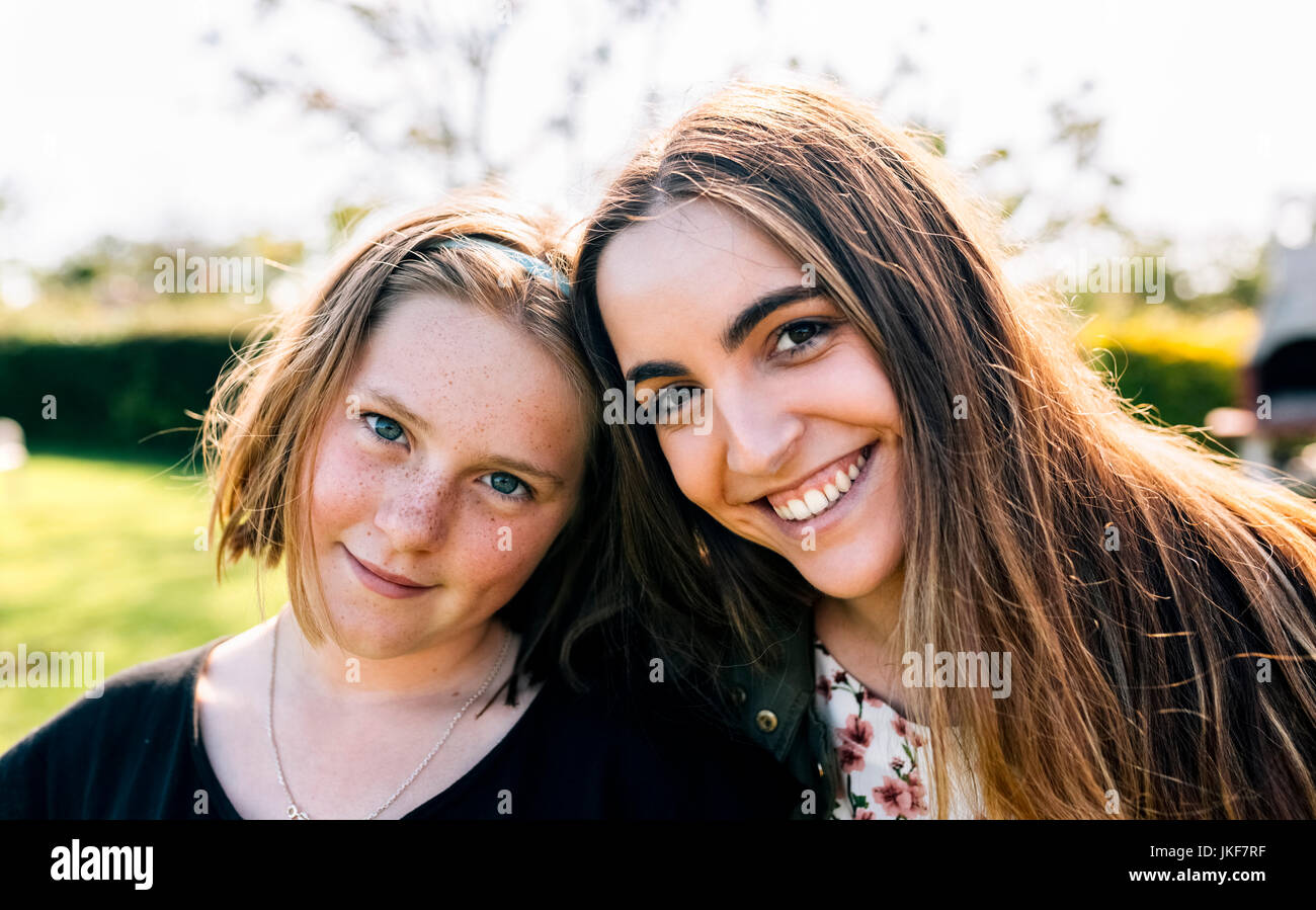 Portrait of two smiling girls outdoors Stock Photo - Alamy