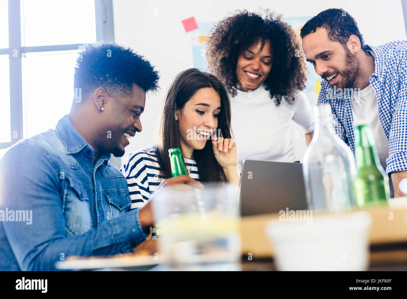 Friends at dining table sharing laptop Stock Photo - Alamy