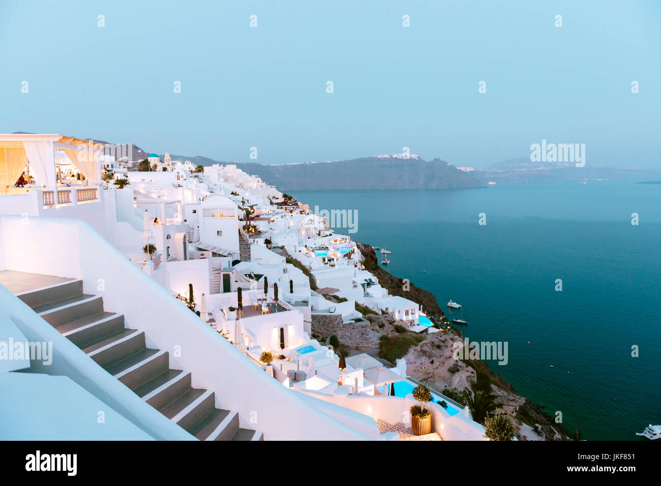 Santorini, Greece. White houses over the Santorini caldera in Oia, with Imerovigli and Fira in the background. Stock Photo